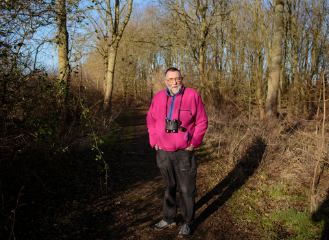 Vic stands in a woodland