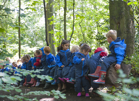children in blue overalls in woods
